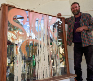 Taron Stanley standing next to his winning work "Sick".